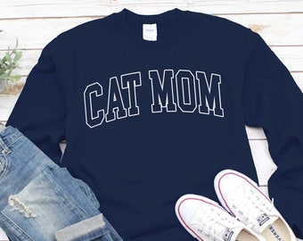 May include: A navy blue sweatshirt with the text "CAT MOM" in white outlined letters.