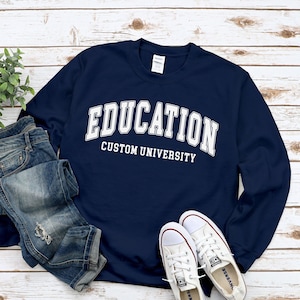 May include: Navy blue sweatshirt with white text that reads "EDUCATION CUSTOM UNIVERSITY".