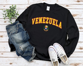 May include: Black sweatshirt with a yellow arch reading "VENEZUELA" and the Venezuelan coat of arms in the center.