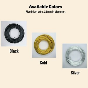 May include: Three spools of aluminium wire, 2.5mm in diameter, in black, gold, and silver.