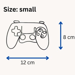 K&ouml;nnte beinhalten: Ein schwarzes Drahtmodell eines Videospiel-Controllers. Das Modell ist 12 cm breit und 8 cm hoch. Gr&ouml;&szlig;e: klein