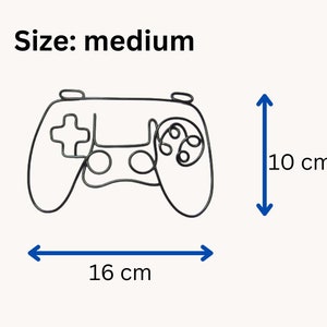 K&ouml;nnte beinhalten: Eine schwarze Drahtgitter-Umrandung eines Videospiel-Controllers, 16 cm breit und 10 cm hoch. Gr&ouml;&szlig;e: mittel.