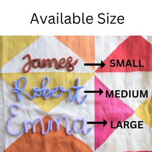 May include: Three knitted names, "James", "Robert", and "Emma", are displayed on a colorful patchwork fabric background. Arrows point to the right, indicating the size of each name: "SMALL", "MEDIUM", and "LARGE".