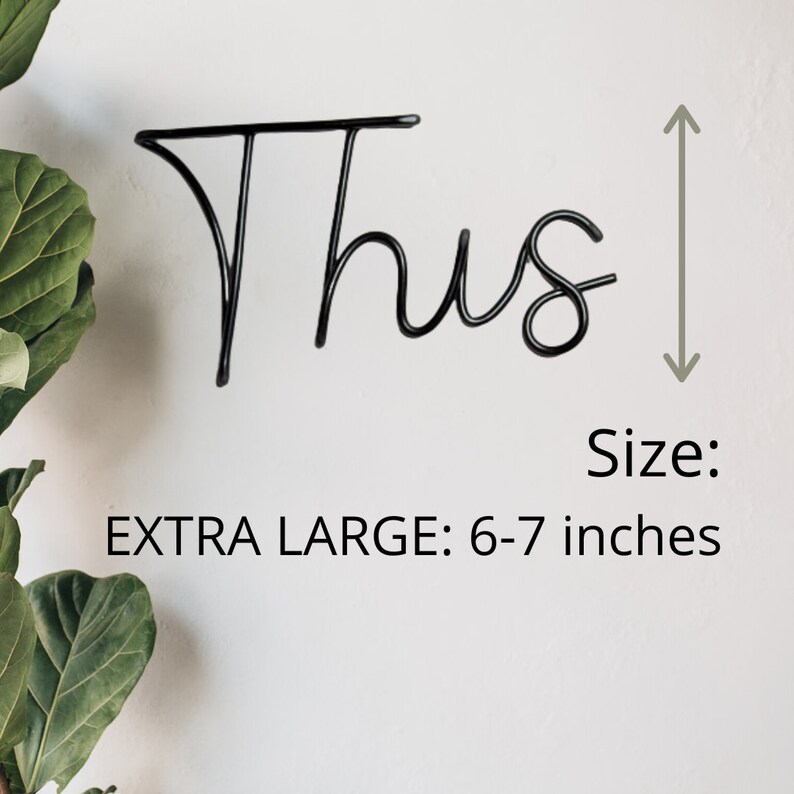 May include: Black metal word art that says "Thus" in a cursive font. The word art is 6-7 inches tall.