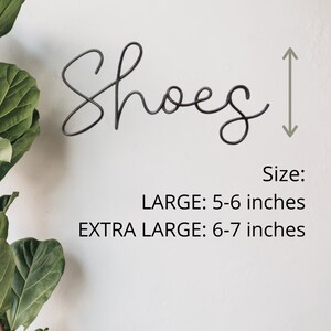 May include: Metal wire word art that says "Shoes" in a cursive font. The word art is 5-6 inches tall in the large size and 6-7 inches tall in the extra large size.
