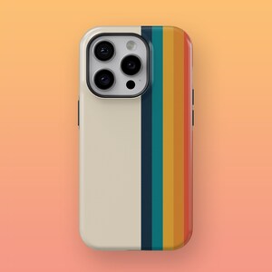 May include: A white phone case with a vertical stripe of rainbow colors. The case has a camera lens cutout with three black circles.