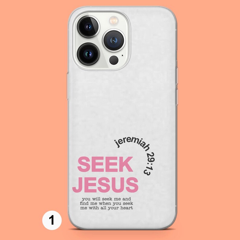 May include: White phone case with a pink and black design that says "jeremiah 29:13 SEEK JESUS you will seek me and find me when you seek me with all your heart"