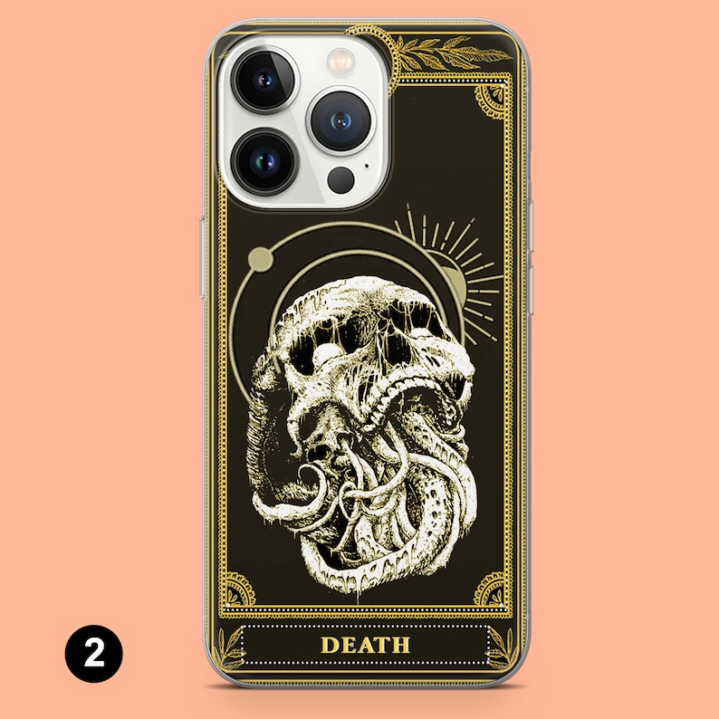 May include: A clear phone case with a black background and gold accents. The case features a graphic of a skull with tentacles, surrounded by a circle and a sun. The text "DEATH" is printed in gold at the bottom of the case.