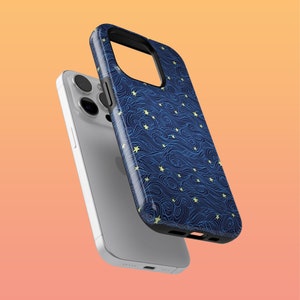 May include: A blue phone case with a white and yellow pattern of stars and waves. The case is shown on top of a white phone.