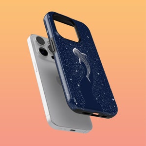 May include: A navy blue phone case with a white whale shark silhouette against a starry background. The case is designed for an iPhone.