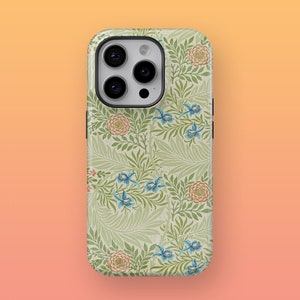 May include: A green, white, and blue floral phone case with a camera lens cutout. The case features a repeating pattern of flowers and leaves.