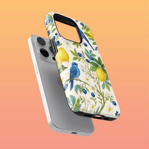 May include: A phone case with a botanical design featuring yellow lemons, blue birds, and white flowers on a cream background. The case is shown with a silver phone.