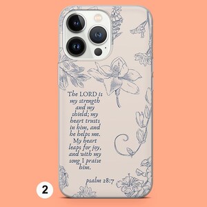May include: A clear phone case with a floral design and a quote from Psalm 28:7. The quote reads: "The LORD is my strength and my shield; my heart trusts in him, and he helps me. My heart leaps for joy, and with my song, I praise him."