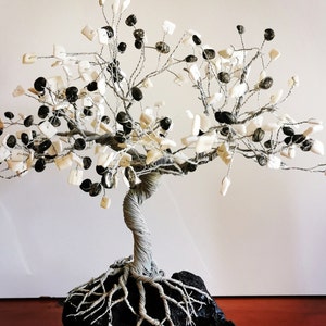 Gray  wire tree on the black stone
