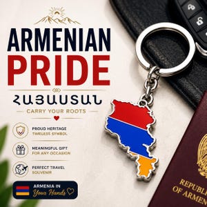 May include: A silver keyring with an Armenian map-shaped pendant in red, blue, and orange. The keyring is displayed next to a passport and car key. The image also includes the text "Armenian Pride" and "Carry Your Roots."