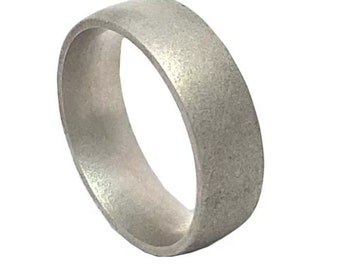 May include: A silver wedding band with a brushed finish.