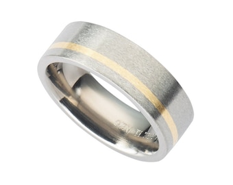 May include: A silver wedding band with a thin gold band around the center.