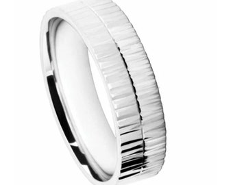 May include: A silver wedding band with a textured, grooved design.