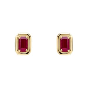 May include: A pair of gold earrings with a red gemstone in each. The gemstones are set in a square shape with a slightly rounded edge.