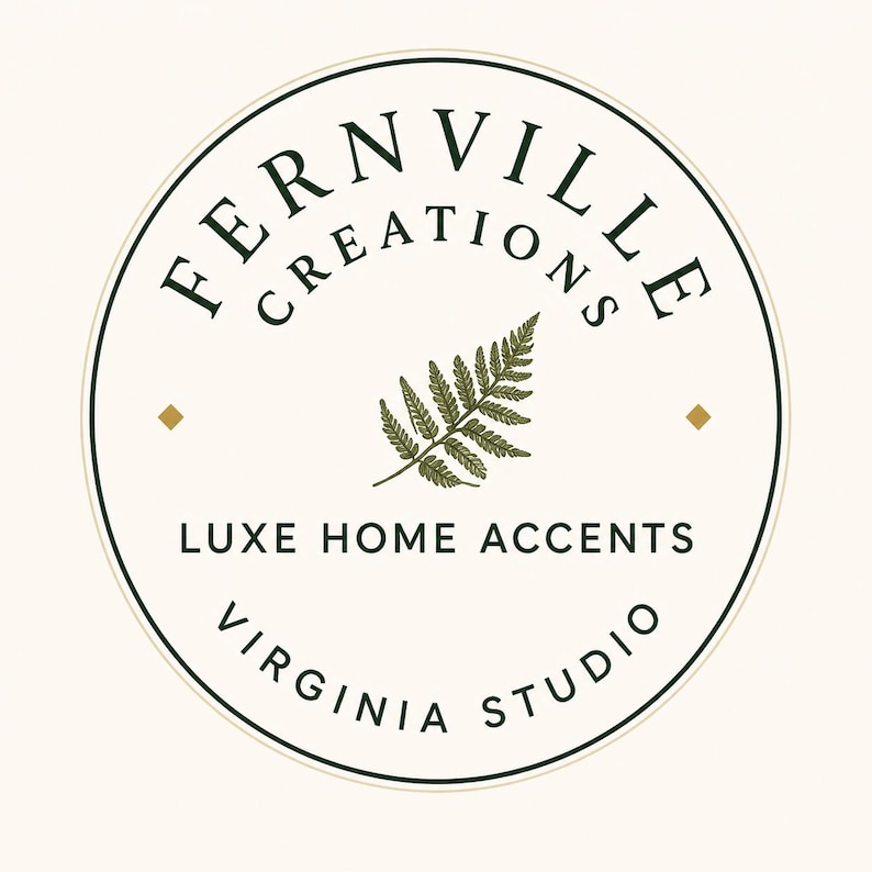 May include: A circular logo on a cream background featuring the dark green text FERNVILLE CREATIONS arched at the top. A central dark green fern leaf graphic is flanked by two small gold diamonds. Below, the text reads LUXE HOME ACCENTS and VIRGINIA STUDIO.