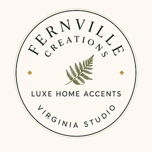 Round logo with the text Fernville Creations Luxe Home Accidents Virginia Studio surrounding a green fern illustration.