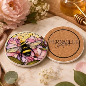 The front and back of the ceramic coaster, showing the bumblebee floral design on the left and the cork backing with Fernville Creations text on the right.