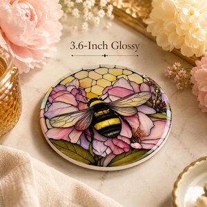 A 3.6-inch glossy ceramic coaster with a bumblebee and pink floral design, displayed on a marble surface with flowers and text reading 3.6-Inch Glossy.