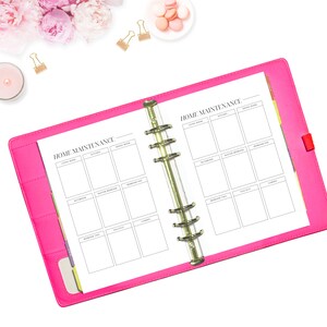 May include: A pink binder with a white page open to a home maintenance checklist. The checklist is divided into sections for each room of the house, including the living room, kitchen, bathroom, master bedroom, bedroom two, hallway, and garden.
