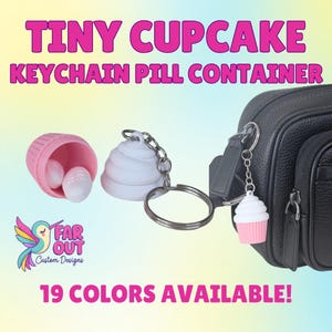 May include: A pink and white cupcake keychain pill container with a silver chain attached to a black bag. The text "TINY CUPCAKE KEYCHAIN PILL CONTAINER" is displayed in pink. The image also shows a pink pill container with white pills.