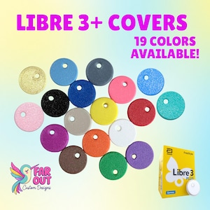 May include: A collection of 19 colored round covers for Libre 3+ sensors, each with a small hole. The colors include gold, blue, black, pink, yellow, red, white, green, and purple. The image also shows a Libre 3 Plus sensor box and a sensor.