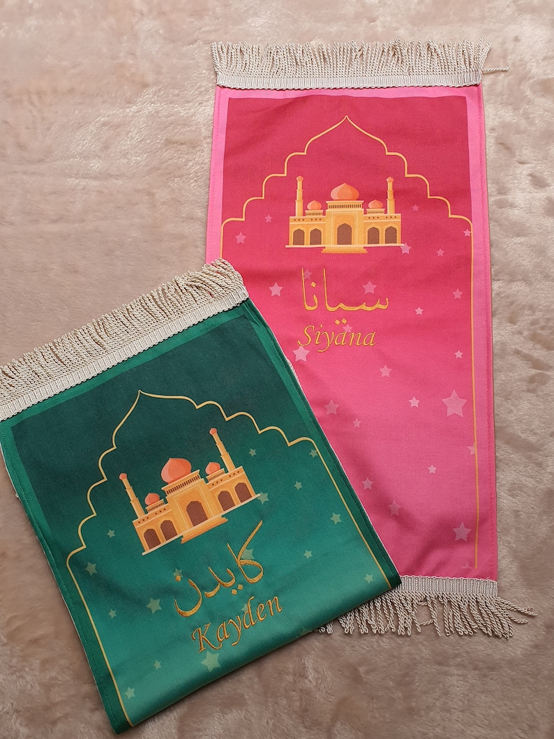 May include: Two personalized prayer rugs with gold mosque designs and Arabic text. The green rug says "Kayden" and the pink rug says "Siyiana".