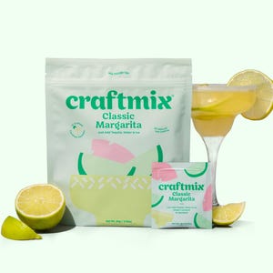 May include: Two pouches of craftmix classic margarita mix, one large and one small, with a glass of margarita and lime slices on a white background.