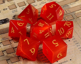 May include: Set of six red, translucent dice with gold numbers. The dice are in various positions on a brown surface with a game board.