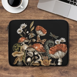 May include: A black laptop sleeve with a colorful illustration of mushrooms, butterflies, dragonflies, and flowers on a dark background.