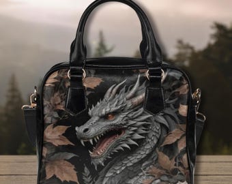 May include: Black leather handbag with a dragon design. The dragon is gray and has red eyes. The bag has a shoulder strap and two top handles.