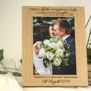 A wooden frame with personalised engraving to give as a wedding favour to the Parents/Father/Mother of the Bride. This design has a contemporary and aesthetic fonts for the name's of who is getting married and the date of the wedding.
