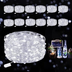 May include: A collection of twelve coiled strands of white LED fairy lights on thin silver wire, each with a small white battery pack. The lights emit a bright glow, and a small inset image shows the lights inside glass bottles and jars.