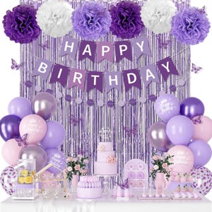 May include: A purple and silver birthday party decoration set. The set includes balloons, a banner that reads "Happy Birthday", a cake, and decorative pom-poms. The color scheme is purple, silver, and white.
