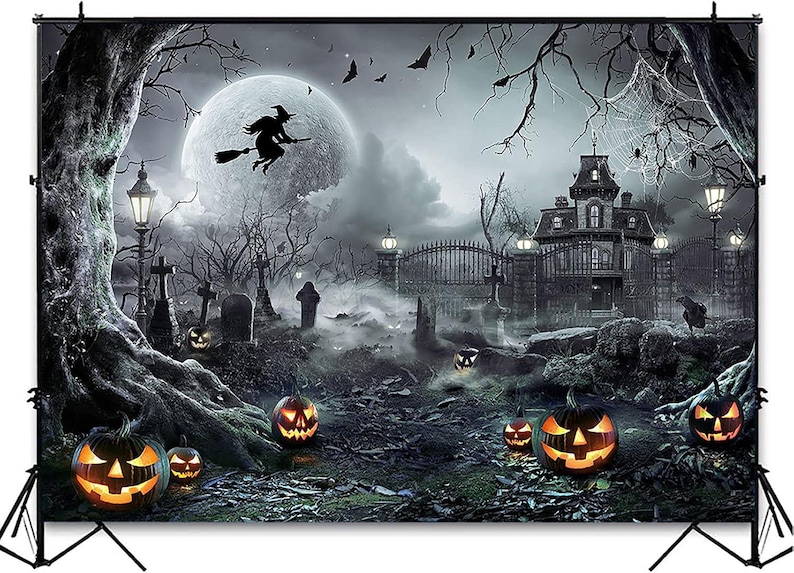 May include: Halloween backdrop featuring a spooky scene with a full moon, a witch on a broom, and a haunted house. Lit jack-o'-lanterns and a graveyard add to the eerie atmosphere. The backdrop is supported by a black stand.