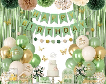 May include: A festive birthday party scene with green, gold, and white decorations. Includes balloons, a banner that reads "Happy Birthday", paper pom-poms, and a three-tiered cake. Butterflies and various desserts complete the celebratory setup.