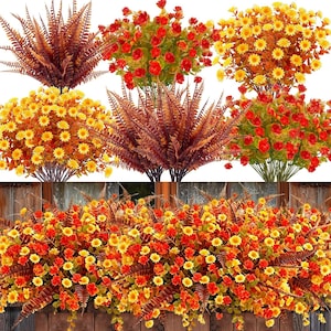 May include: A collection of artificial floral arrangements featuring clusters of red roses, yellow daisies, and brown ferns. The display includes individual bouquets of each variety and a long, dense horizontal arrangement combining all three types.