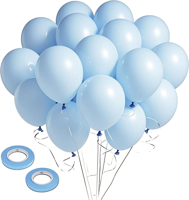 May include: A cluster of light blue balloons tied together with silver ribbons. Two rolls of blue double-sided tape are in the foreground. The balloons are a pastel color, suitable for a party or celebration.