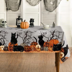 May include: A light gray rectangular tablecloth featuring a repeating Halloween pattern of black cats, orange pumpkins, and bare tree silhouettes. The design includes pumpkins with black and orange patterns and text that reads Trick or Treat.