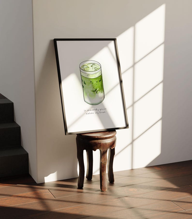 May include: A framed watercolour illustration of a green iced matcha drink in a glass with the text "So somebody gonna make me my green matcha" underneath.