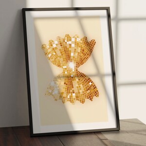May include: A framed print of a gold glitter bow tie shape on a cream background.