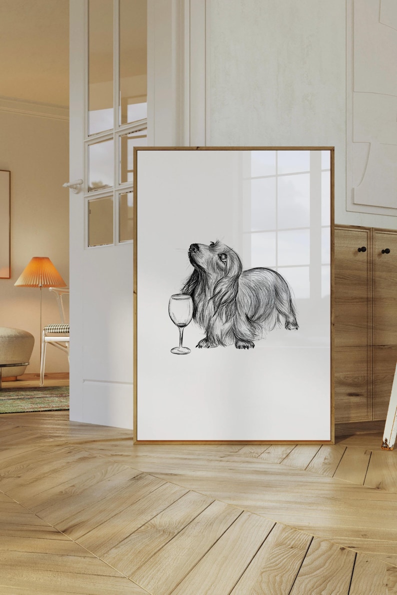 A drawing of a dachshund with a glass of wine. The drawing is framed. The drawing is black and white, but is available on several background colours including pink, orange, yellow, blue, green and purple.
