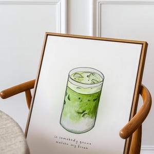 May include: A framed illustration of a glass of iced matcha with the text "is somebody gonna matcha my freak" underneath.