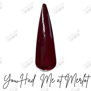 May include: A single, long, dark red nail polish bottle with the text "You Had Me at Merlot" written below it.