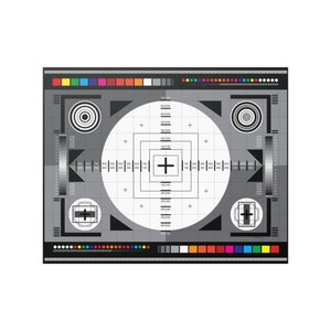 May include: A black and white test pattern with a grid, circles, and a plus sign in the center. The pattern is used to adjust television and video equipment.