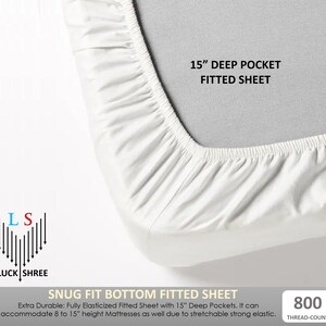 May include: White fitted sheet with a 15" deep pocket. The sheet is made of a durable, elasticized fabric and is designed to fit mattresses up to 15" high. The sheet has a thread count of 800. The text "SNUG FIT BOTTOM FITTED SHEET" is printed on the bottom of the image.